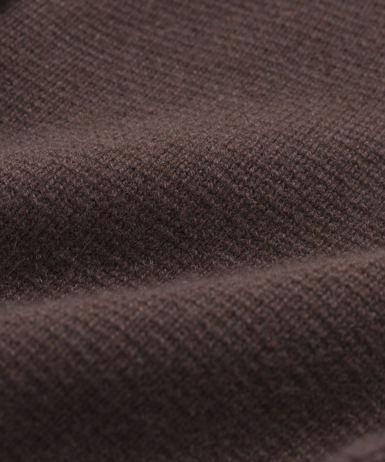 Close-up of brown textured fabric with a visible knit pattern and soft folds, ideal for showcasing the structured silhouette and versatile style of the Cooper Cardigan.